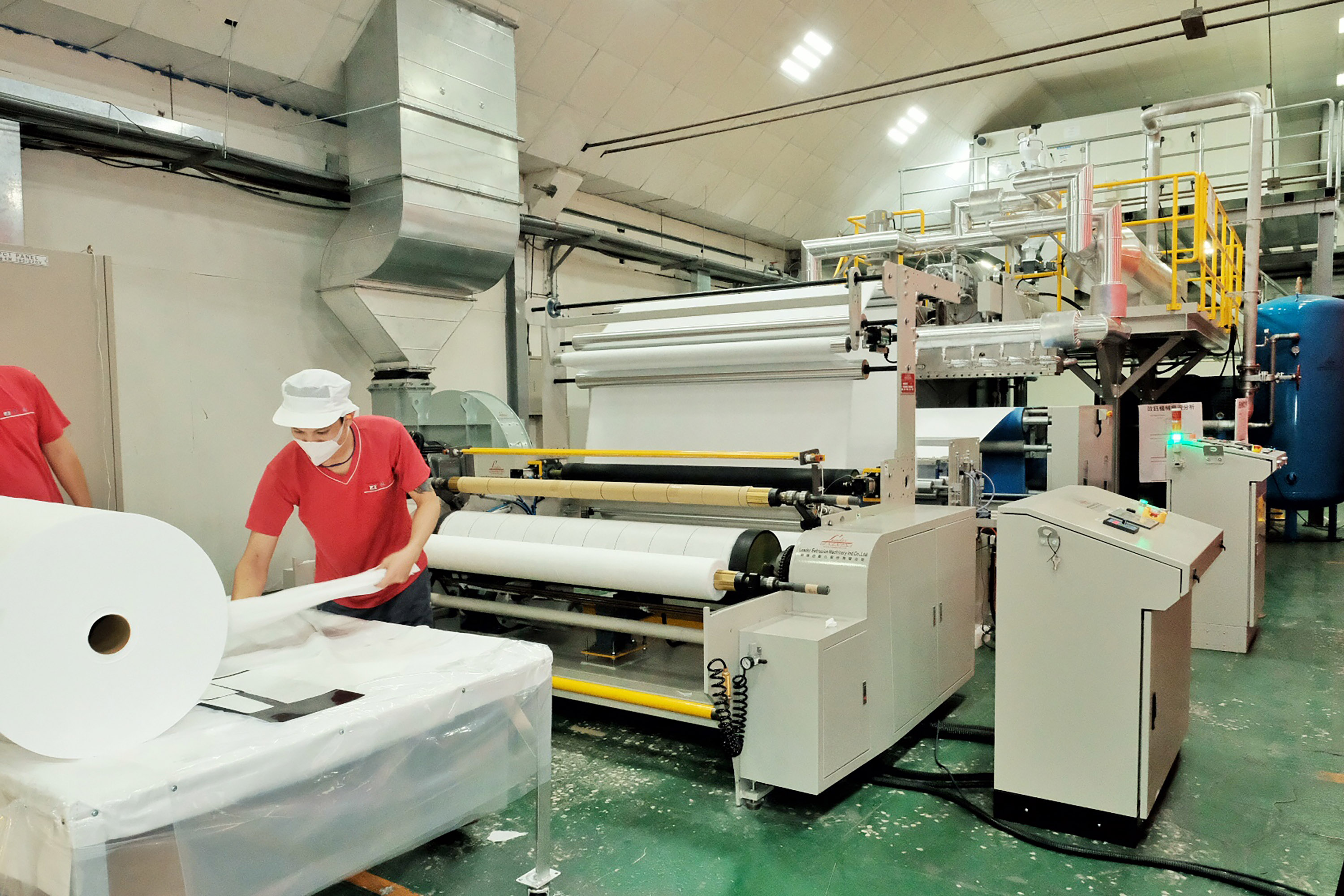 New Southbound Policy。Workers turn out nonwoven fabrics used in producing surgical masks at the Mytrex Health Technologies Inc. melt-blown line July 1 in northern Taiwan’s Taoyuan City. (CNA)