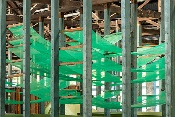 Nylon withering nets that superseded the old cypress racks hang from the original ceiling trusses to facilitate moisture evaporation from fresh leaves. (Photo By Chen Mei-ling)