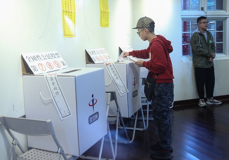 Seorang pemilih memasukan surat suara ke dalam kotak pada pemungutan suara nasional yang dilaksanakan bersamaan dengan pilkada pada tanggal 24 November 2018