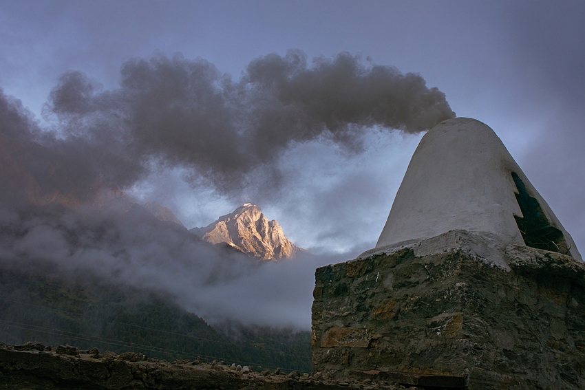 Sherpas piously recite the Padmasambhava Mantra every morning. They burn incense during the recitation, which marks the beginning of each day. Shown in the background here is Phari Lapcha, one of the holy mountains. (photo by Tony Lee)