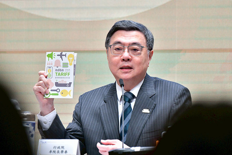 Premier Cho Jung-tai displays a brochure showing government initiatives to support industries during a press conference detailing Taiwan’s tariff negotiations with the U.S. Jan. 20 in Taipei City. (Courtesy of Executive Yuan)